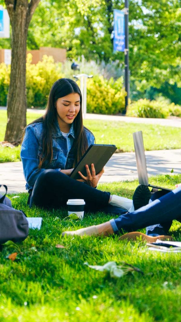 college-students-sitting-together-outside-on-campus